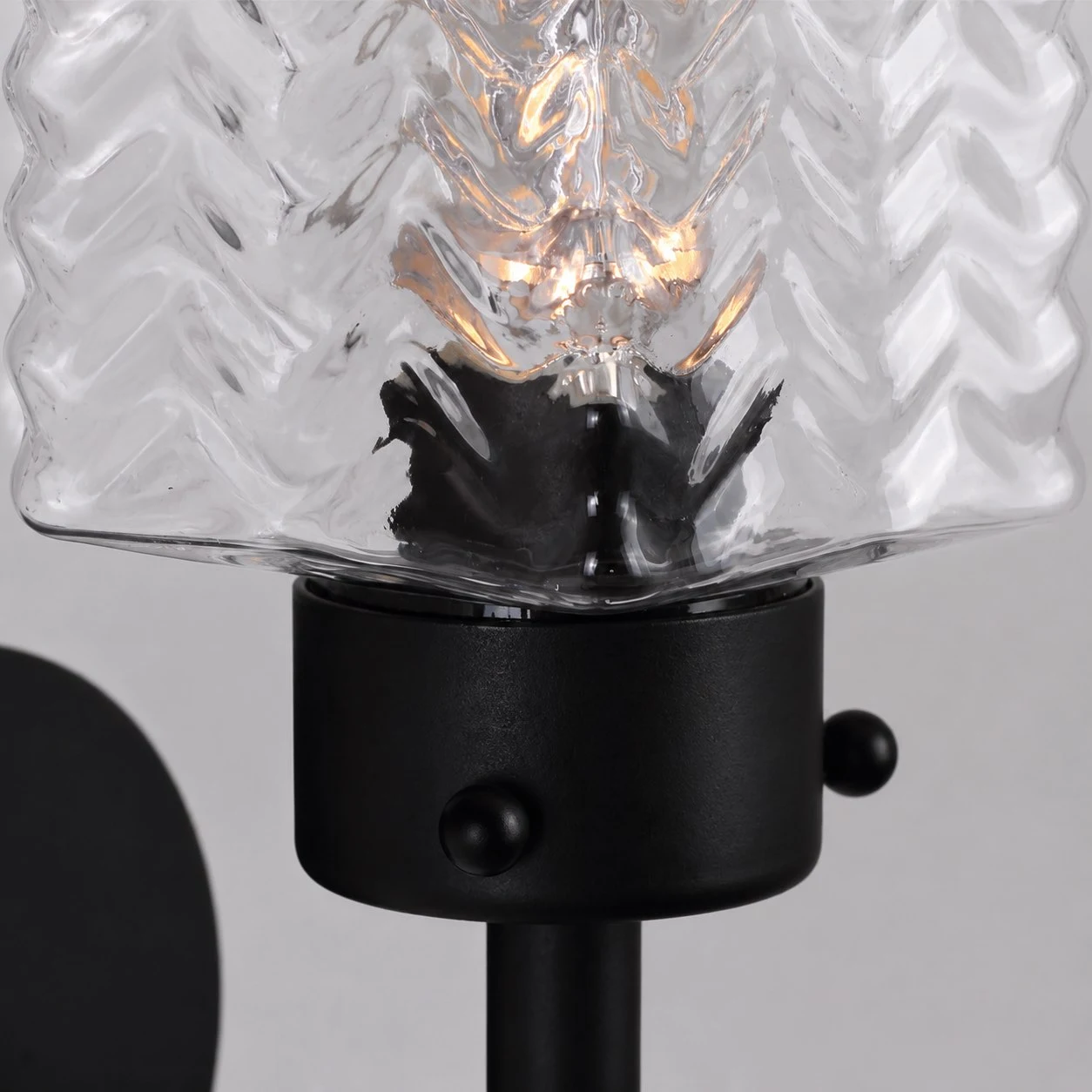 Close view of rippled glass shade with warm bulb