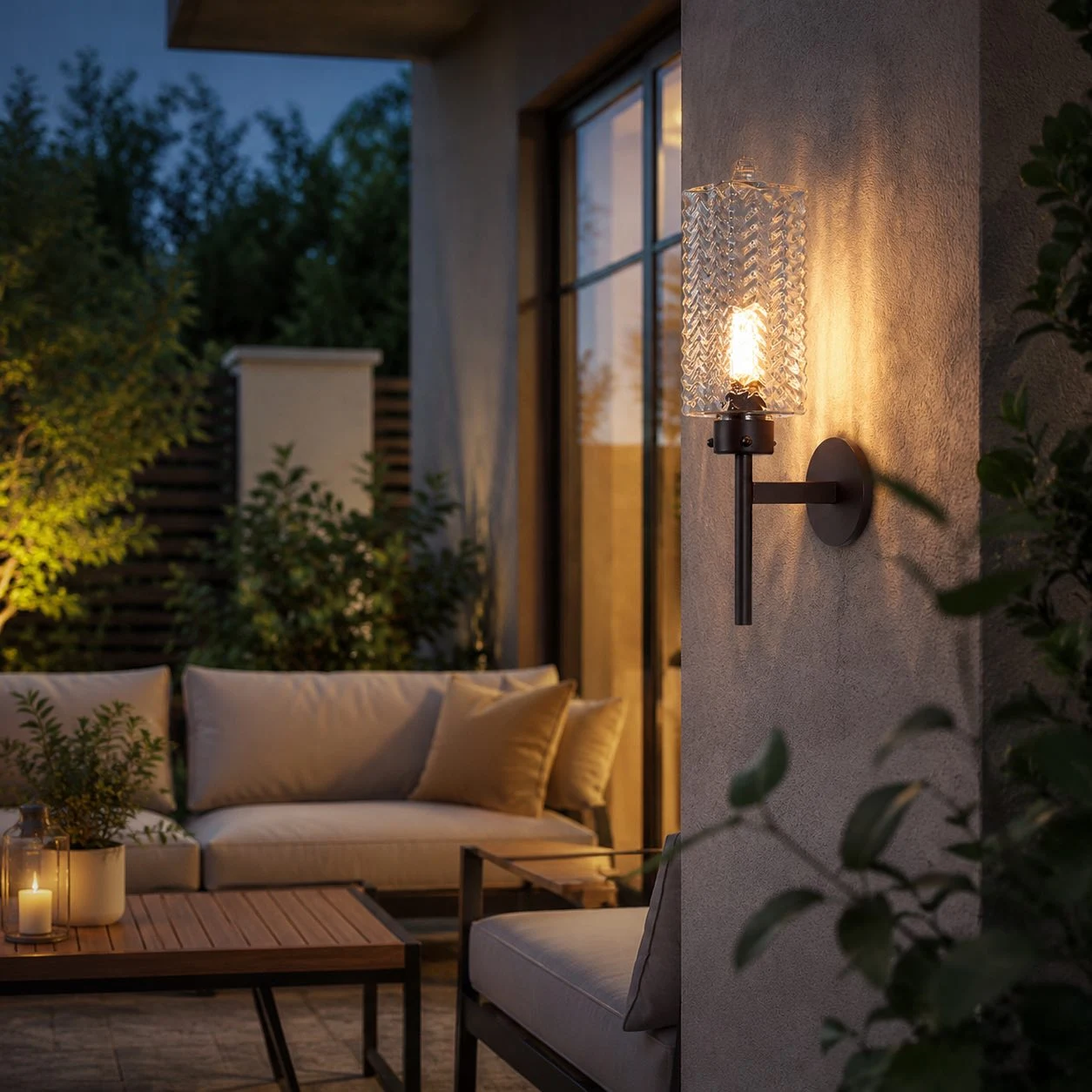 Outdoor wall sconce lit beside seating area
